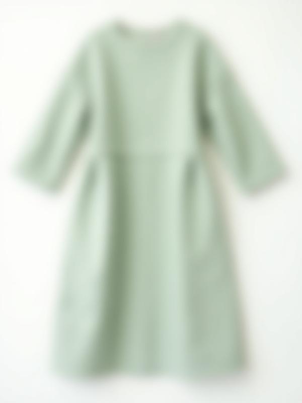 A simple, elegant linen midi dress in a soft, muted color, laid flat